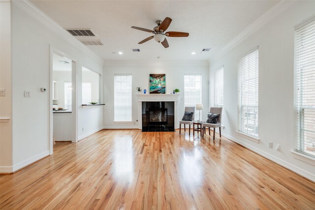 2827 Briarhurst Park, Houston, TX 77057 - living room with visible vents, light wood finished floors, crown molding, a ceiling fan, and a tiled fireplace