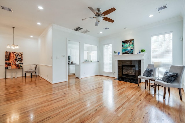 2827 Briarhurst Park, Houston, TX 77057 - living area featuring a fireplace, crown molding, light wood-type flooring, and visible vents