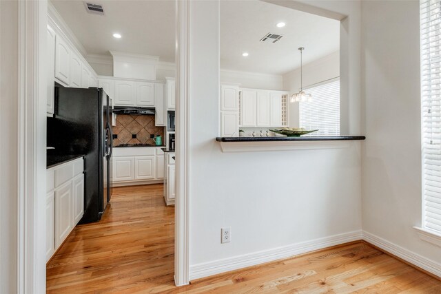 2827 Briarhurst Park, Houston, TX 77057 - kitchen with white cabinetry, dark countertops, black refrigerator with ice dispenser, and visible vents