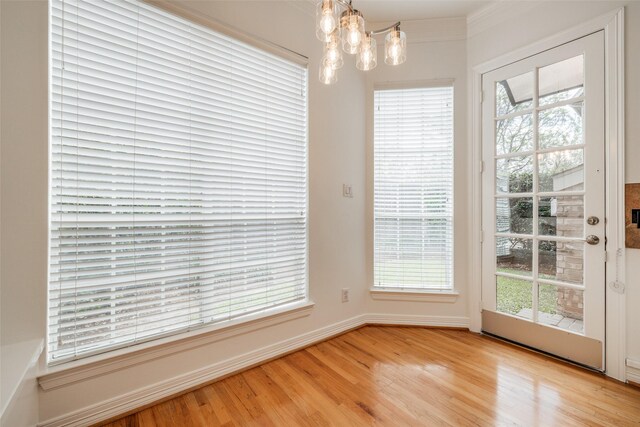 2827 Briarhurst Park, Houston, TX 77057 - unfurnished dining area with an inviting chandelier, light wood-type flooring, and baseboards