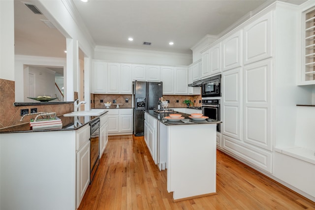2827 Briarhurst Park, Houston, TX 77057 - kitchen featuring a sink, dark countertops, white cabinetry, visible vents, and black appliances