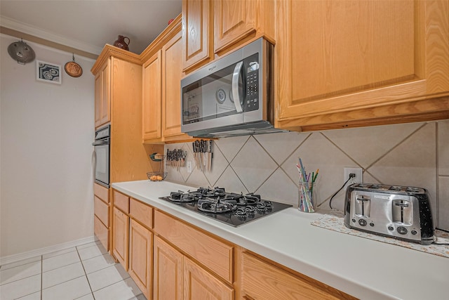 kitchen with black appliances, backsplash, light tile patterned floors, light countertops, and light brown cabinets