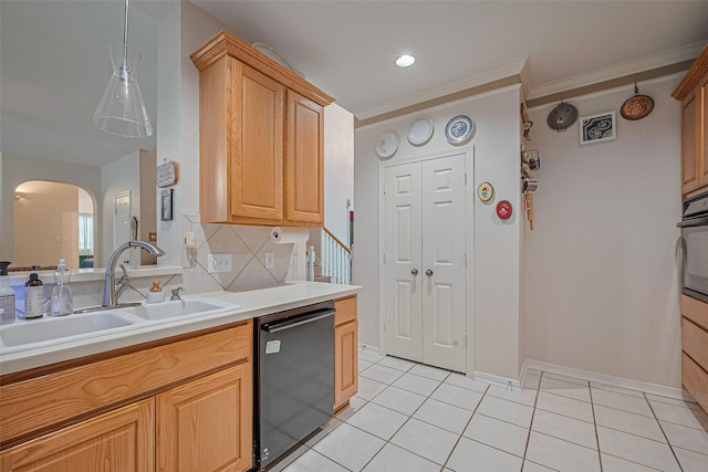 kitchen featuring dishwasher, arched walkways, a sink, light countertops, and light tile patterned flooring