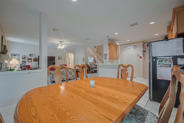dining area with stairs, arched walkways, light tile patterned floors, ceiling fan, and recessed lighting