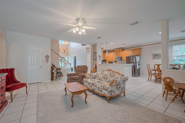 living room featuring light tile patterned flooring, stairway, and ceiling fan