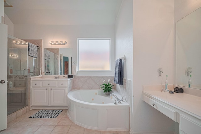 bathroom with a shower stall, a whirlpool tub, tile patterned floors, and vanity