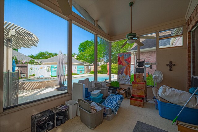 sunroom with a ceiling fan and lofted ceiling