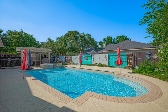 view of pool with fence, a patio, a pergola, and a pool with connected hot tub