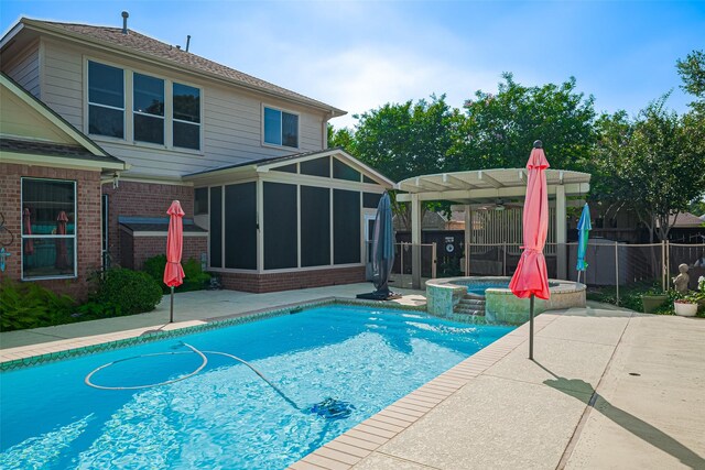 view of pool with a sunroom, a patio, and fence