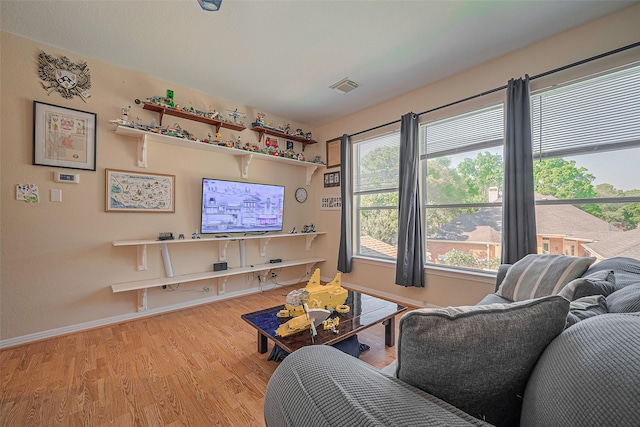 living area with wood finished floors and baseboards