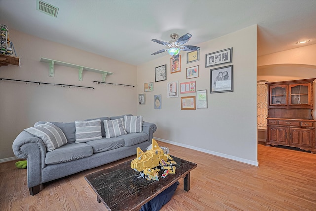 living area with ceiling fan, light wood-type flooring, and baseboards