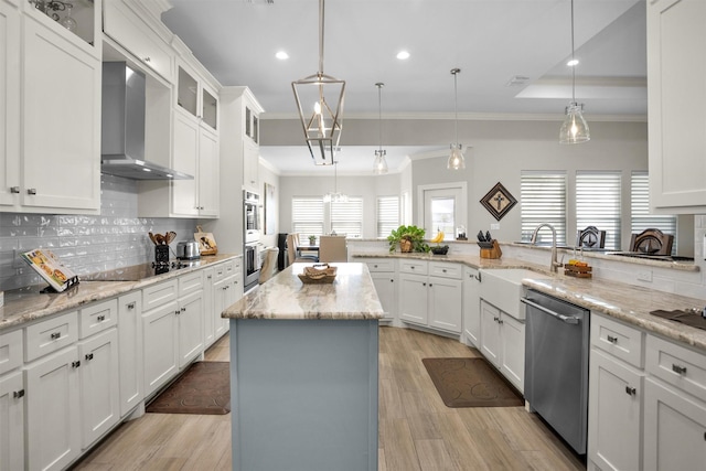 kitchen with a sink, wall chimney exhaust hood, crown molding, stainless steel dishwasher, and black electric cooktop