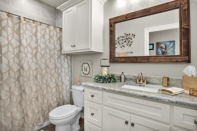 bathroom featuring toilet, a shower with curtain, and vanity