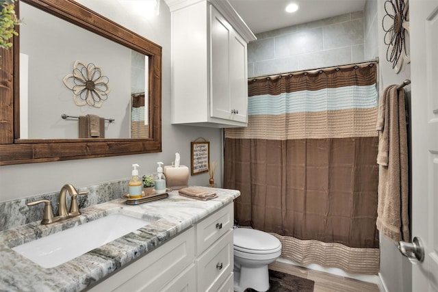 bathroom featuring toilet, wood finished floors, vanity, curtained shower, and recessed lighting