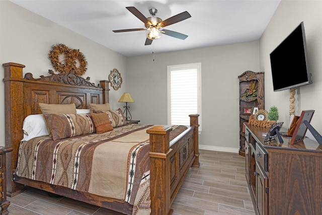 bedroom featuring ceiling fan, wood finish floors, and baseboards