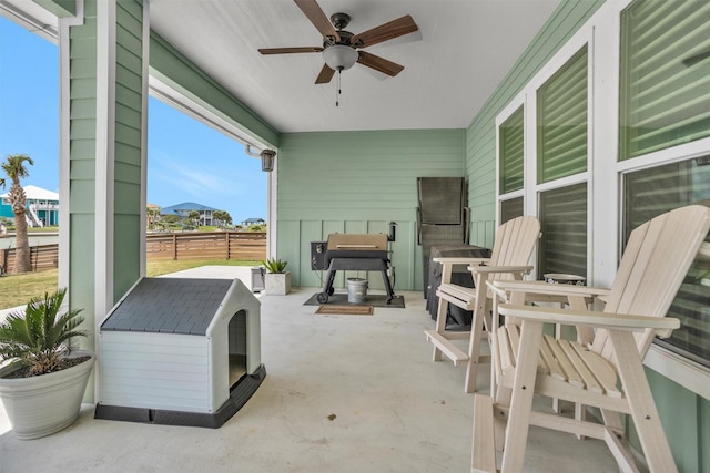 view of patio with fence and ceiling fan
