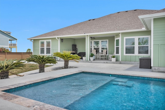 view of swimming pool featuring a patio area, a fenced in pool, and fence