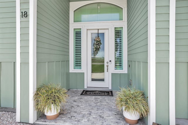 view of exterior entry featuring board and batten siding