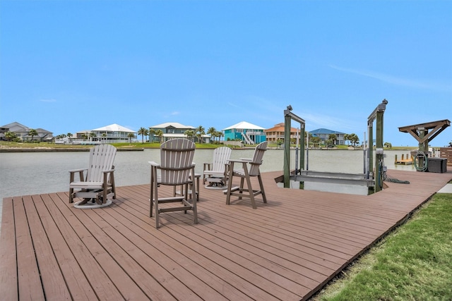 view of dock featuring boat lift, a water view, and a residential view