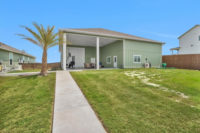 back of property featuring a yard, board and batten siding, a patio, and fence