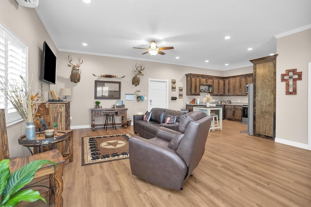 living room featuring a ceiling fan, light wood-style floors, a healthy amount of sunlight, and recessed lighting