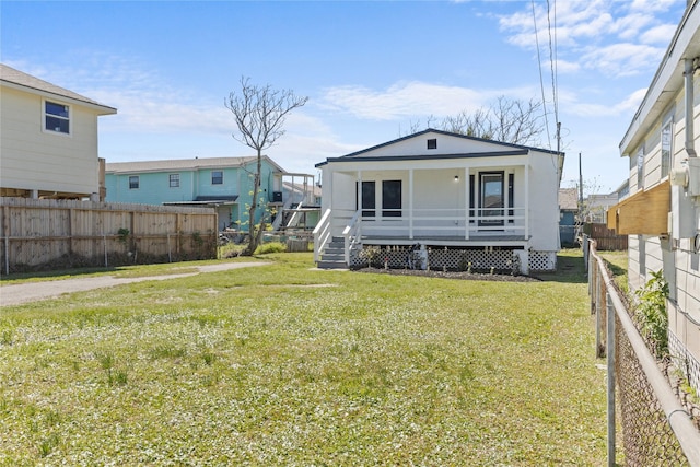 view of front of house featuring a porch, a front yard, and a fenced backyard