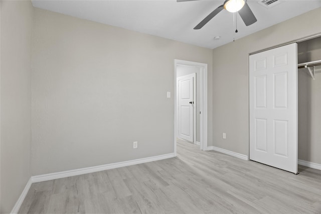 unfurnished bedroom with baseboards, a closet, a ceiling fan, and light wood-style floors