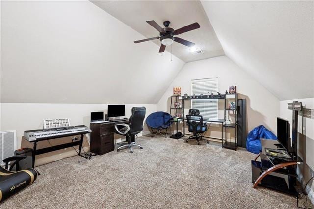 home office with vaulted ceiling, carpet flooring, a ceiling fan, and visible vents