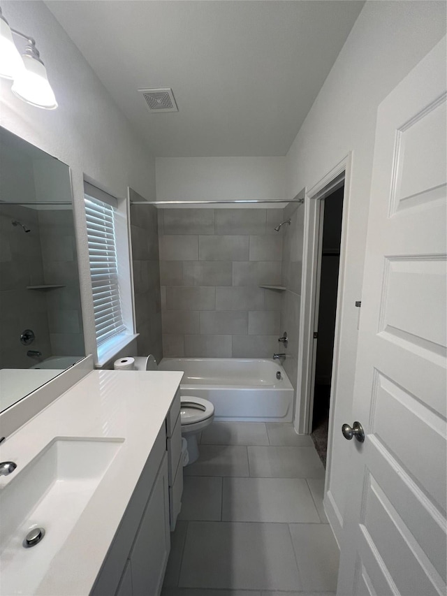 bathroom with toilet, visible vents, tile patterned flooring, vanity, and shower / washtub combination