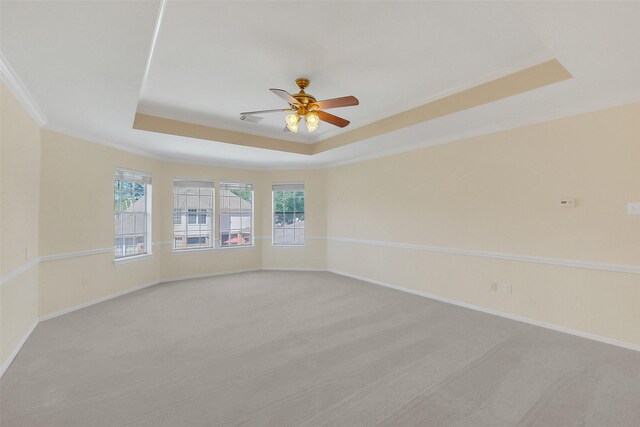 14906 Stonemeade Pl, Cypress, TX 77429 - spare room with ceiling fan, light carpet, crown molding, a raised ceiling, and baseboards