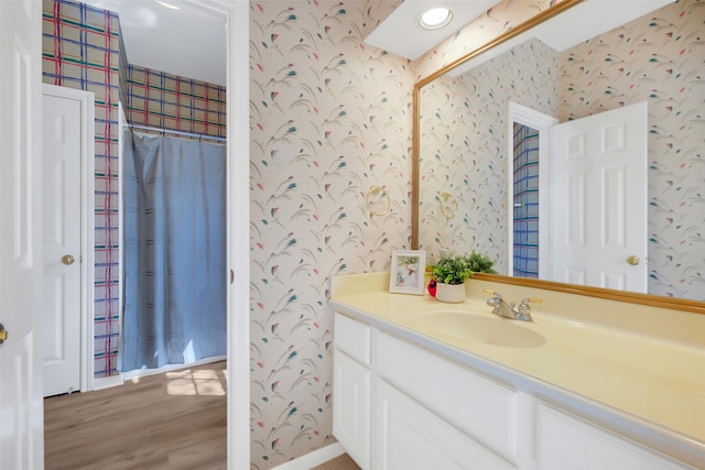 14906 Stonemeade Pl, Cypress, TX 77429 - bathroom featuring wallpapered walls, wood finished floors, and vanity