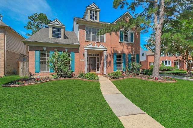 14906 Stonemeade Pl, Cypress, TX 77429 - colonial inspired home featuring roof with shingles, brick siding, and a front lawn