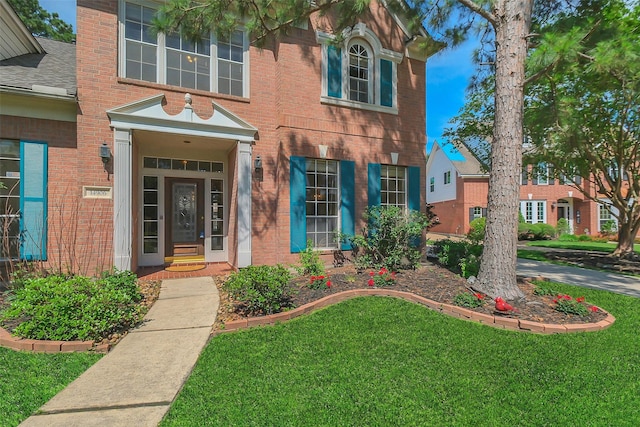 14906 Stonemeade Pl, Cypress, TX 77429 - view of front of home with a front lawn, brick siding, and roof with shingles