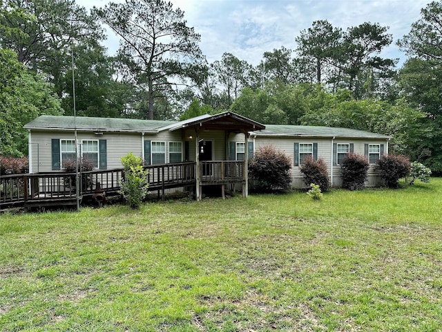 manufactured / mobile home with a deck and a front yard