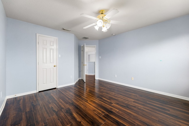 empty room featuring baseboards, dark wood-style floors, and ceiling fan