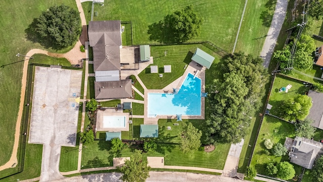 aerial view of property and surrounding area featuring a pool