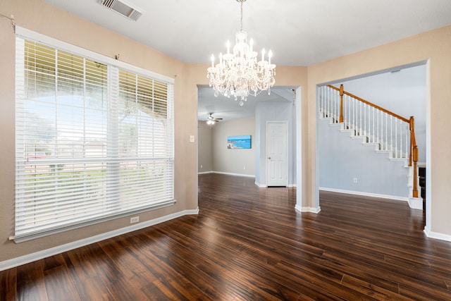 unfurnished dining area with a chandelier, stairway, wood finished floors, and baseboards