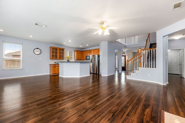unfurnished living room featuring a ceiling fan, baseboards, stairway, dark wood finished floors, and recessed lighting