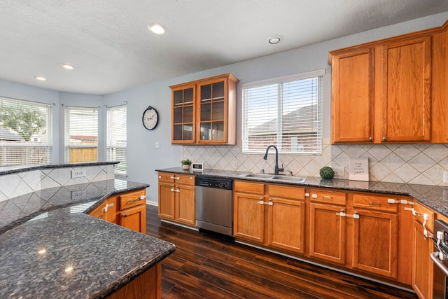kitchen with a sink, dishwasher, dark wood-type flooring, brown cabinetry, and recessed lighting
