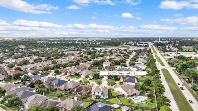 aerial view of property's location with nearby suburban area and a pool