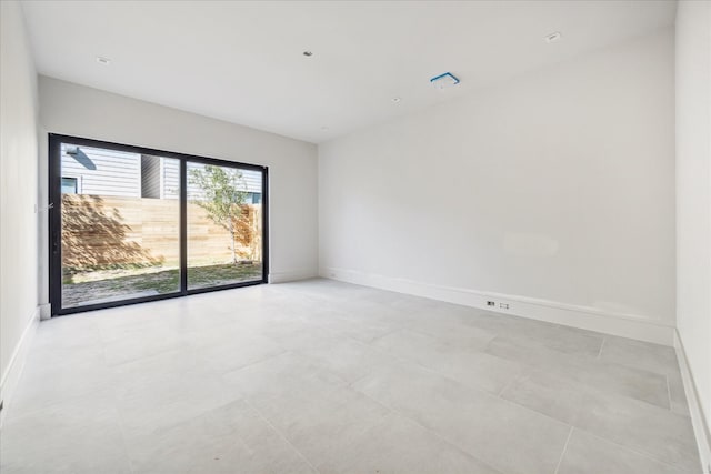unfurnished room with baseboards