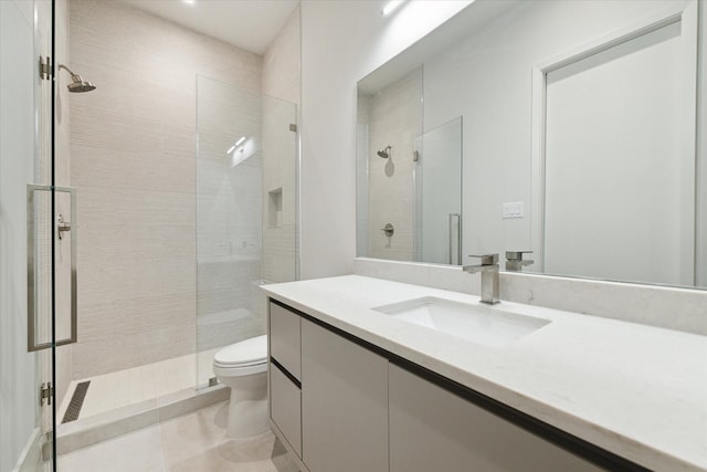 full bathroom with toilet, tile patterned flooring, vanity, and a stall shower