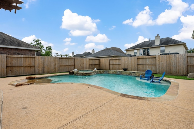 view of swimming pool featuring a patio, a fenced backyard, and a pool with connected hot tub