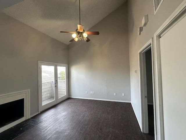 unfurnished living room with french doors, high vaulted ceiling, dark wood finished floors, baseboards, and ceiling fan