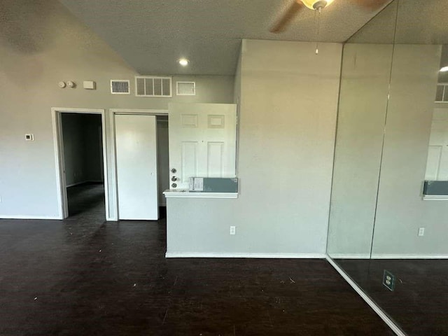 unfurnished room with ceiling fan, baseboards, and visible vents
