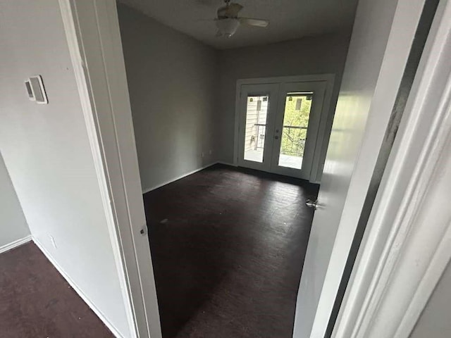 interior space with french doors, baseboards, and ceiling fan