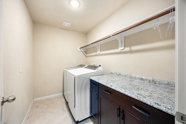 29014 Jacobs River Dr, Katy, TX 77494 - laundry room featuring washing machine and dryer, cabinet space, baseboards, and light tile patterned floors