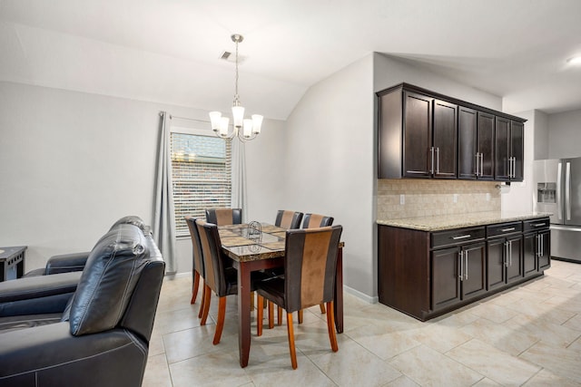 29014 Jacobs River Dr, Katy, TX 77494 - dining area with a chandelier, lofted ceiling, baseboards, and light tile patterned floors