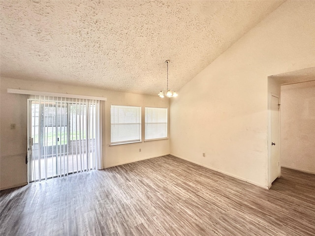4230 E Terrace Creek Cir, Houston, TX 77014 - unfurnished room featuring vaulted ceiling, a notable chandelier, a textured ceiling, and wood finished floors