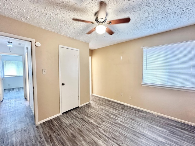 4230 E Terrace Creek Cir, Houston, TX 77014 - unfurnished bedroom featuring a ceiling fan, a closet, a textured ceiling, baseboards, and wood finished floors
